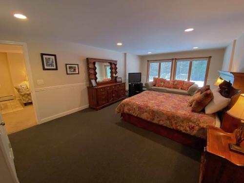 a large bedroom with a bed and a mirror at Spacious private home - AL132 in Carroll