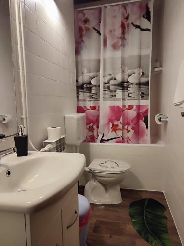 a white bathroom with a sink and a toilet at Apartment Belvedere in Brela
