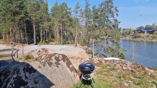 a helmet sitting on top of a rock next to a lake at Summer cottage at seafront with private jetty in Oskarshamn