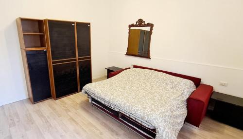 a bedroom with a bed and a mirror on the wall at "Giulio Cesare" - Ampio ed elegante alloggio alle porte di Milano! in Bareggio