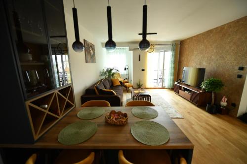 a living room with a table and a couch at Apartman Milja in Požega