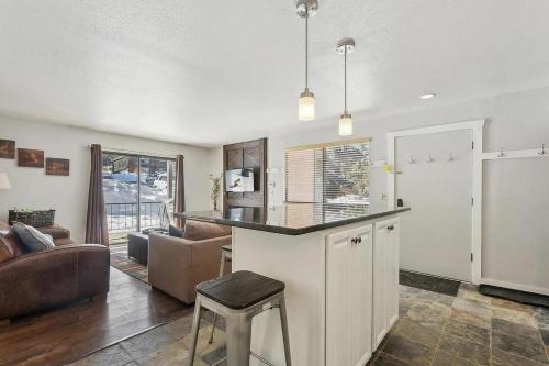 a kitchen with a bar and a living room at The Powder Haven Chalet in Park City