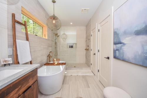 a bathroom with a tub and a sink and a shower at Eagle's View in Dadeville