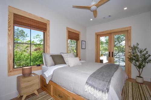 a bedroom with a large bed and two windows at Eagle's View in Dadeville