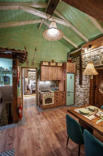 a kitchen with a table and a stove top oven at Archontiko Theofanous in Tríkala