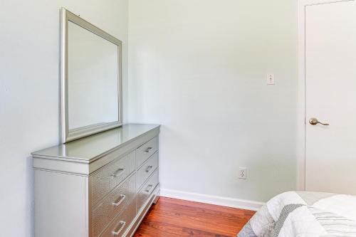 a bedroom with a dresser with a mirror on it at Patio, Fire Pit and Yard Family Home in Pearland in Pearland