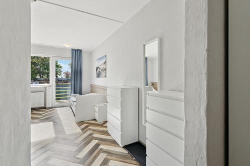 a dressing room with white furniture and a window at Sali Homes - Ferienwohnung in Kevelaer - Comfort in Kevelaer