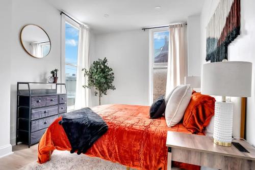 a bedroom with a bed and a dresser and a mirror at Urban Nest #2 Vibrant suite downtown by Proctors in Schenectady