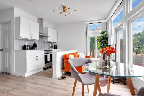 a kitchen and dining room with a glass table at Urban Nest #3 Bright loft steps to Proctors in Schenectady
