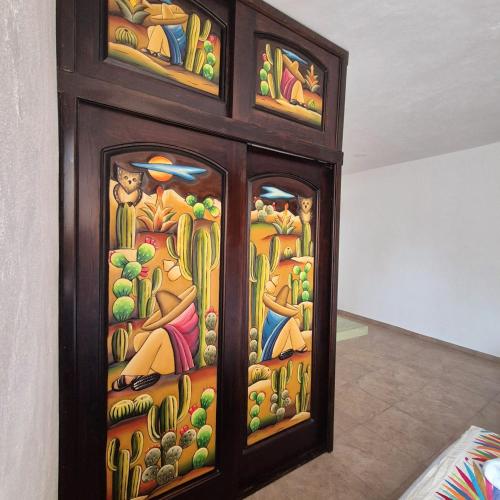 a wooden cabinet with a stained glass window at Hotel Villas Ponto Holbox in Holbox Island