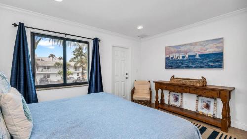 a bedroom with a bed and a window at Designer Beachside Serenity Steps to the Beach! in Juno Beach