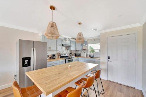 a kitchen with a wooden table and orange chairs at Sunrise Suite Central to I75 airport & downtown in Punta Gorda