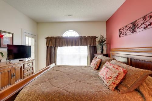 a bedroom with a bed and a tv and a window at 2 Mi to Broadway at the Beach Myrtle Beach Condo in Myrtle Beach