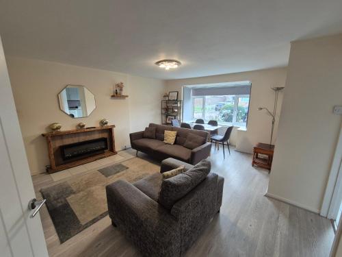 a living room with a couch and a fireplace at Cosy and Nice Apartment in Borehamwood