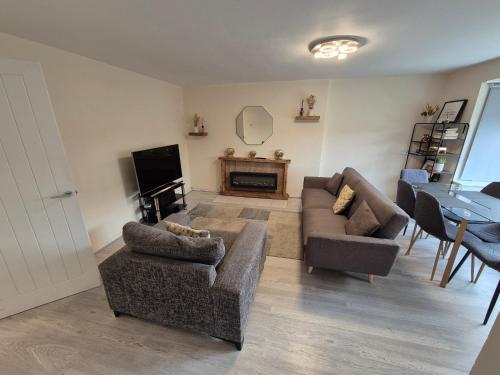 a living room with two couches and a television at Cosy and Nice Apartment in Borehamwood