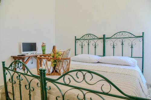 a bedroom with a green metal bed with a desk at Le Sciosce in San Giorgio Lucano