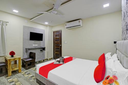 a hotel room with a bed and a fireplace at Collection O Hotel Raj Palace in Vadodara