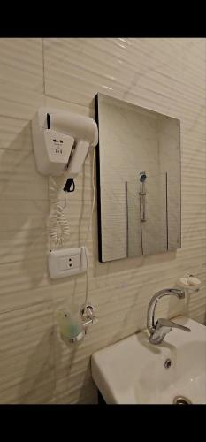 a bathroom with a sink and a mirror at VIP Hotel Amman in Amman
