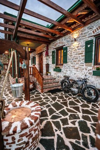 a motorcycle parked in a stone building with a stone floor at Archontiko Theofanous in Tríkala