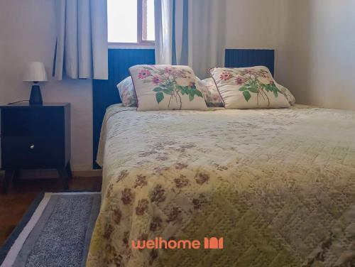a bed with two pillows on it in a bedroom at Cobertura com Vista e Conforto no RS in Santo Ângelo