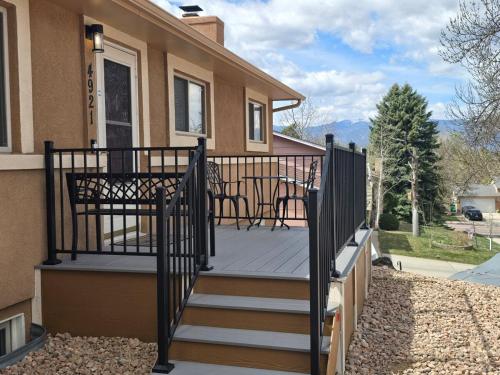 a deck with a table and chairs on a house at Purple Mountain Majestic Retreat in Colorado Springs