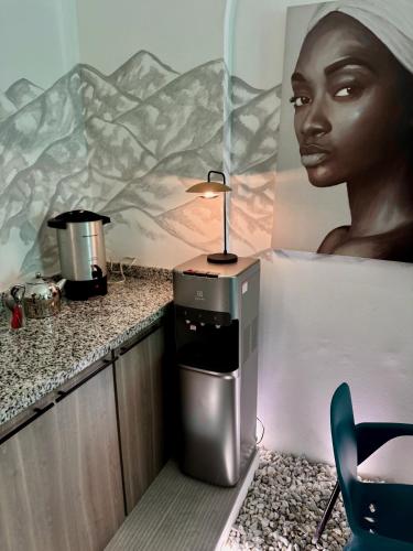 a bathroom with a table with a lamp on a counter at Comunidad Calle 13 Hotel Boutique in Santa Marta