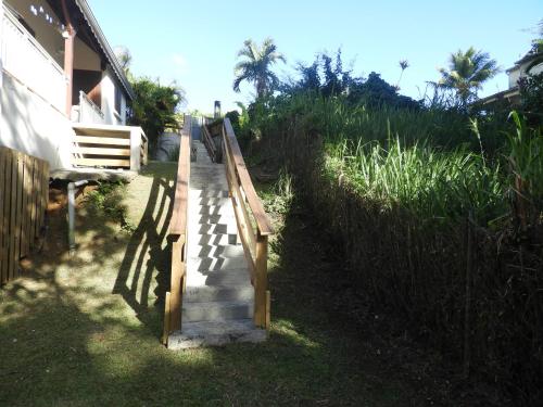 una escalera de madera que conduce a una casa en Cocon Siloé, en Petit-Bourg
