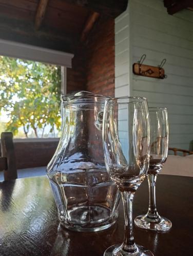 two wine glasses sitting on top of a table at Posada de Nono in Nono