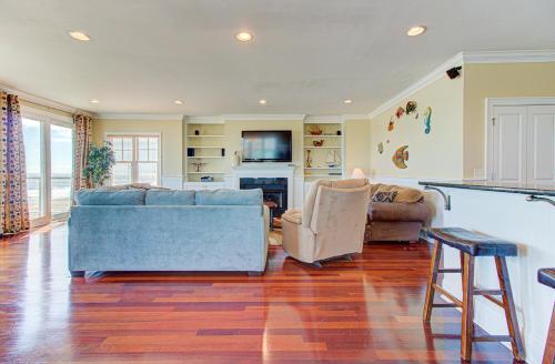 a living room with a couch and two chairs at Ocean Overlook by Carolina Beach Realty in Carolina Beach
