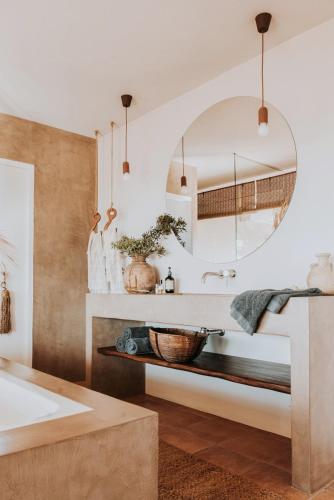 a bathroom with a sink and a mirror at Casa Stellar - boutique villa with private pool and sea view - sustainably solar powered in Sant Josep de sa Talaia