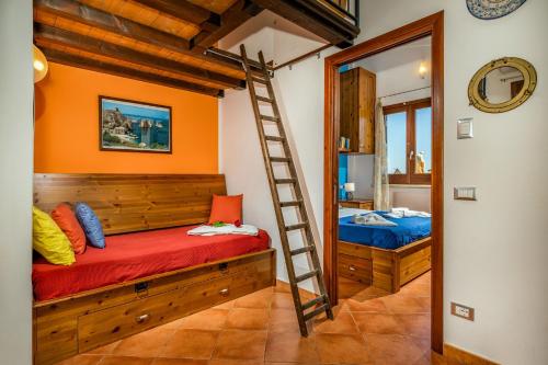 a room with a bunk bed and a ladder at Villa Elena vicino la Riserva naturale dello Zingaro in Scopello