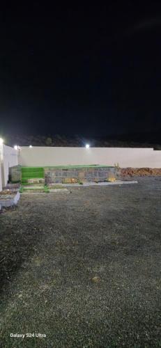 a parking lot in front of a building at night at Sunset view hill jabal shams in Misfāh