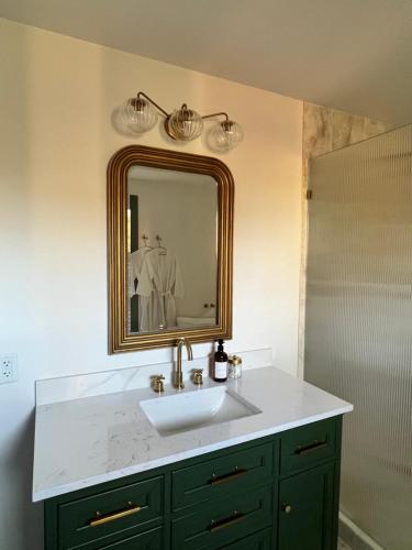 a bathroom with a sink and a mirror at Kaleidoscope Inn & Gardens in Nipomo