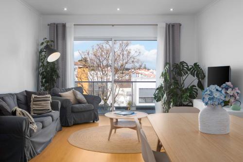 a living room with a couch and a table at Paim Apartments in Ponta Delgada