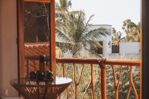 a balcony with a view of a palm tree at Amari Sayulita Boutique Hotel in Sayulita