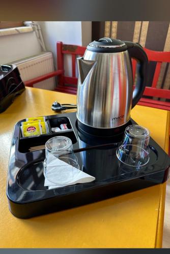 a tea kettle on a tray on a table at CLASS 17 PANSİYON in Canakkale