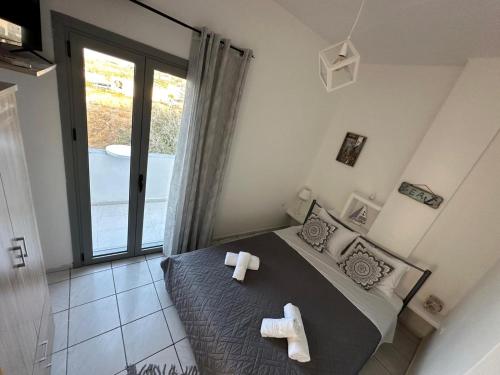 a bedroom with a bed with two crosses on it at Calypso Heaven in Santorini