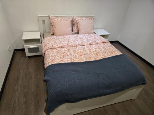 a bedroom with a large bed with pink pillows at Yaël House in Brussels
