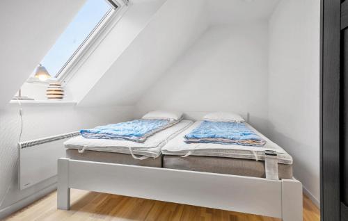 a bed in a room with a window at Three-Bedroom Apartment In Karrebaksminde in Karrebæksminde