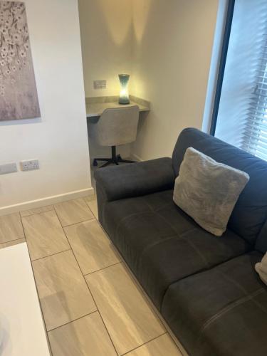 a living room with a couch and a chair at Stylish 1 Bed Apartment in Bicester Town Centre in Bicester