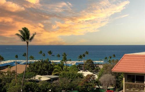 a view of the ocean from a resort at Kailani Kona-Ocean view, top floor Downtown w pool in Kailua-Kona