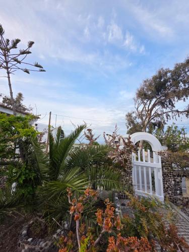 a white fence with a view of the ocean at Calypso Heaven in Santorini