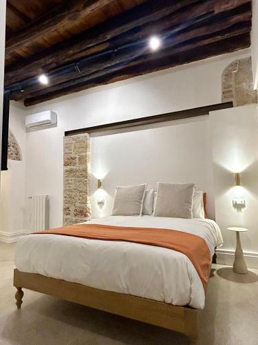 a bedroom with a large bed in a room at Addimura rooms in Palermo