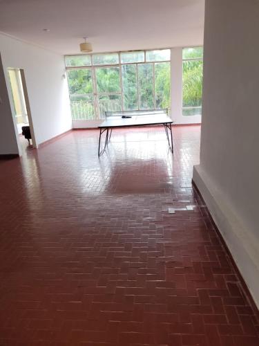 an empty room with a table in the middle of a floor at Casa Al pie del Cerro in Yerba Buena