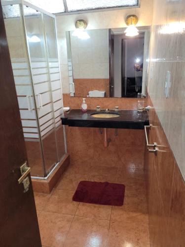 a bathroom with a sink and a mirror at Casa Al pie del Cerro in Yerba Buena