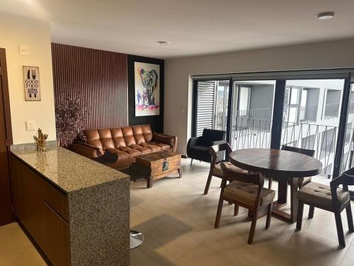a living room with a couch and a table at New apartment in the heart of GDL in Guadalajara