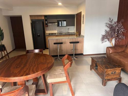 a living room with a wooden table and a couch at New apartment in the heart of GDL in Guadalajara
