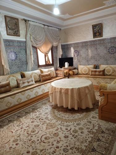 a living room with a couch and a table at Appartement in Benguerir