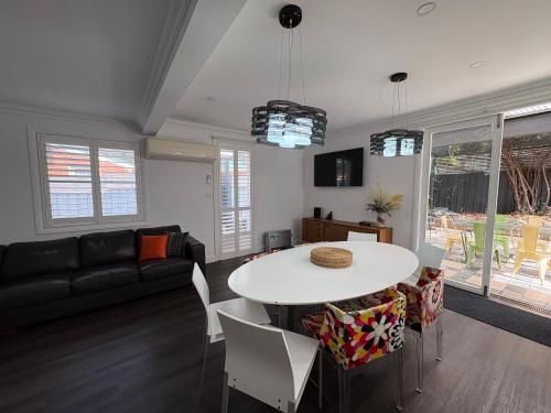 a living room with a table and a couch at Rest on Keppel in Bathurst