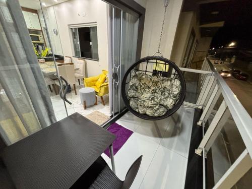 a room with a basket of food on a balcony at Aconchegante in Matinhos